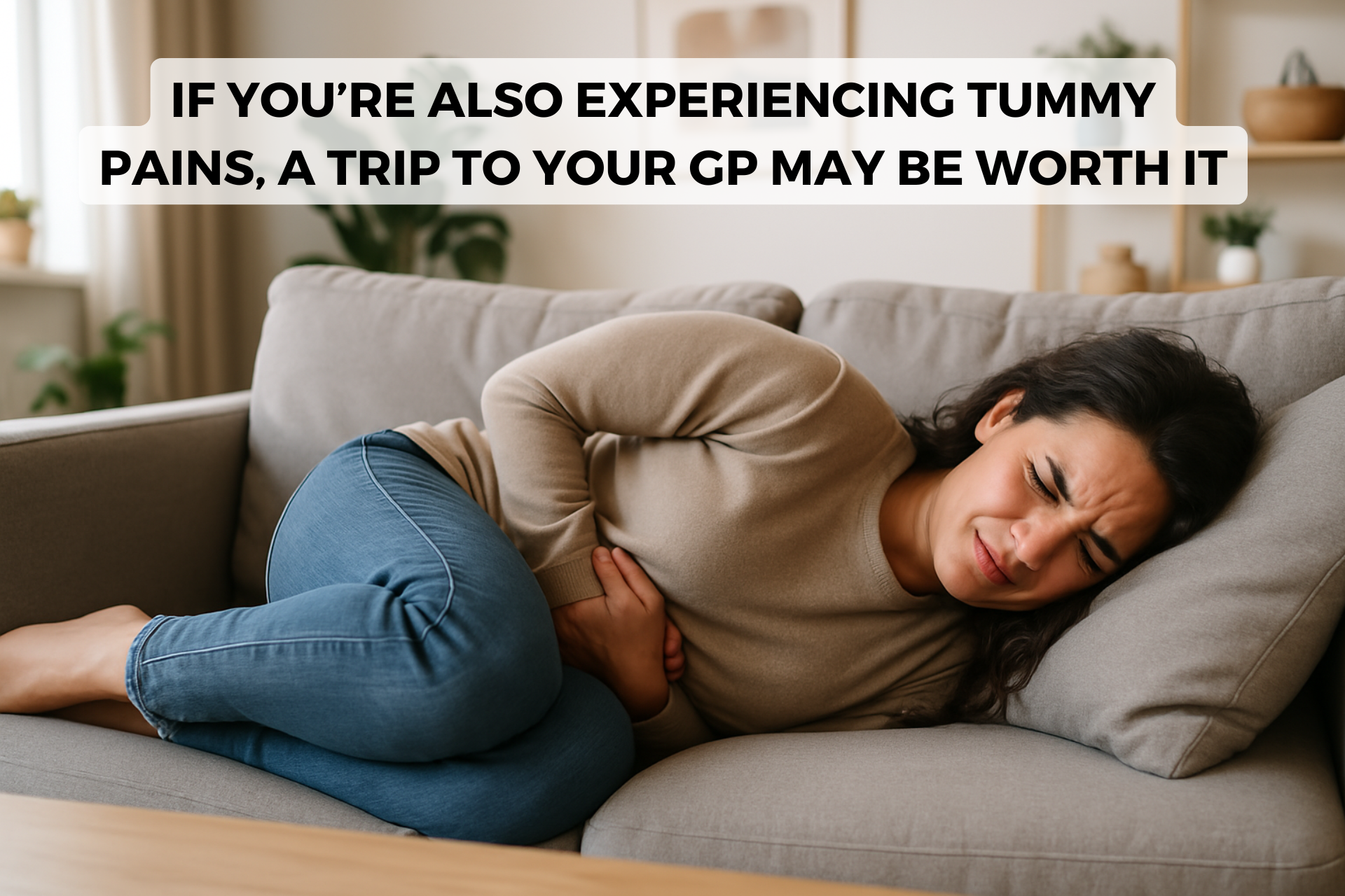 woman on sofa with stomach pain